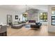 Bright living room featuring a stone fireplace and large windows at 2316 Prometheus Ct, Henderson, NV 89074