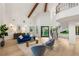 Bright living room showcasing a curved staircase, exposed beams, and modern furnishings at 2316 Prometheus Ct, Henderson, NV 89074