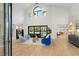 Bright living room with vaulted ceilings, modern furniture, and an oversized sliding door at 2316 Prometheus Ct, Henderson, NV 89074