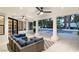 Inviting outdoor living space with a comfortable lounge area overlooking the sparkling pool and lush landscaping at 2316 Prometheus Ct, Henderson, NV 89074