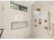 The shower has marble wall tile, a gold shower head and hardware, a built in shelf, and a window at 2316 Prometheus Ct, Henderson, NV 89074