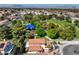 Stunning aerial view showcases home nestled next to a park with mature trees and a playground at 2501 Muirfield Ave, Henderson, NV 89074
