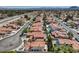 Extensive aerial showcases mature trees, wide streets, and houses with terracotta roofs at 2501 Muirfield Ave, Henderson, NV 89074