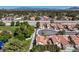 Bright aerial view of community showcasing the park and homes with terracotta roofs at 2501 Muirfield Ave, Henderson, NV 89074