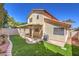 The backyard has artificial turf, desert landscaping, a block wall, a wooden fence, and a covered patio at 2501 Muirfield Ave, Henderson, NV 89074