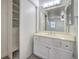 Bright bathroom features white vanity, large mirror and storage closet at 2501 Muirfield Ave, Henderson, NV 89074