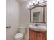 Traditional half bath with decorative framed mirror and elegant vanity at 2501 Muirfield Ave, Henderson, NV 89074