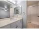 Well-lit bathroom features a large vanity, expansive mirror, and tiled shower at 2501 Muirfield Ave, Henderson, NV 89074