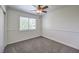 Bedroom featuring neutral carpet, ceiling fan, and bright natural light at 2501 Muirfield Ave, Henderson, NV 89074