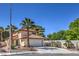 Inviting two-story home featuring a classic tile roof, a two-car garage, and drought-tolerant landscaping at 2501 Muirfield Ave, Henderson, NV 89074