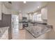 Modern kitchen featuring granite countertops, stainless steel appliances, and ample cabinet space at 2501 Muirfield Ave, Henderson, NV 89074