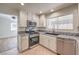 Updated kitchen featuring granite countertops, stainless steel appliances, and a bright window at 2501 Muirfield Ave, Henderson, NV 89074