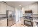 Well-equipped kitchen with stainless steel appliances, granite countertops, and ample cabinet space at 2501 Muirfield Ave, Henderson, NV 89074