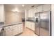 Kitchen with stainless steel refrigerator, granite countertops, and access to the adjacent living spaces at 2501 Muirfield Ave, Henderson, NV 89074