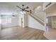 Spacious living room featuring modern flooring, a staircase, and a neutral color palette for versatile decor options at 2501 Muirfield Ave, Henderson, NV 89074