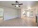 Bright living room with tile flooring, ceiling fan, and access to the backyard through sliding glass doors at 2501 Muirfield Ave, Henderson, NV 89074