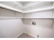 A walk-in closet with tile floor, hanging rod, several shelves, and electrical outlets at 2501 Muirfield Ave, Henderson, NV 89074