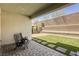 Charming backyard featuring artificial grass, paver patio, and stylish outdoor seating for relaxation at 253 Malpaso St, Las Vegas, NV 89138