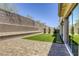 Well-maintained backyard with lush artificial grass, paver patio, and block wall for privacy at 253 Malpaso St, Las Vegas, NV 89138