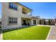 Expansive backyard with synthetic grass and access to both the lower and upper floors at 253 Malpaso St, Las Vegas, NV 89138