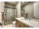Contemporary bathroom with a walk-in shower, modern vanity, and a large mirror, creating a sleek design at 253 Malpaso St, Las Vegas, NV 89138