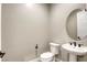 Elegant powder room with pedestal sink, modern fixtures, and neutral tones, perfect for guests at 253 Malpaso St, Las Vegas, NV 89138