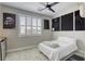 Cozy bedroom featuring a ceiling fan, white bedding and soundproofing at 253 Malpaso St, Las Vegas, NV 89138