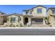Charming two-story home showcasing a well-manicured lawn, a paver driveway, and a two-car garage at 253 Malpaso St, Las Vegas, NV 89138