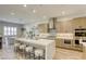 Modern kitchen with sleek countertops, stainless steel appliances, and a spacious center island with seating at 253 Malpaso St, Las Vegas, NV 89138