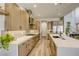 Modern kitchen with stainless steel appliances, light wood cabinetry and beautiful herringbone backsplash at 253 Malpaso St, Las Vegas, NV 89138