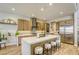 A spacious kitchen featuring a large island with seating and stainless steel appliances at 253 Malpaso St, Las Vegas, NV 89138