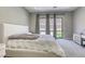 Comfortable main bedroom with a large bed, neutral color scheme, and views of the backyard at 253 Malpaso St, Las Vegas, NV 89138