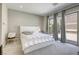 Serene main bedroom with a large bed, neutral color palette, and sliding glass doors to the backyard at 253 Malpaso St, Las Vegas, NV 89138