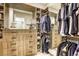 Spacious walk-in closet with custom storage, including drawers, shelves, and hanging rods, providing a luxurious organizing space at 253 Malpaso St, Las Vegas, NV 89138