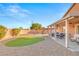 Spacious backyard features a covered patio with seating, artificial turf, and a play area for outdoor enjoyment at 2720 Mickey Mantle Ct, Las Vegas, NV 89108