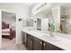 Bathroom featuring dual vanities and a doorway leading to the bedroom at 2720 Mickey Mantle Ct, Las Vegas, NV 89108
