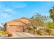 Charming single-story home with a two-car garage, manicured landscaping, and inviting curb appeal at 2720 Mickey Mantle Ct, Las Vegas, NV 89108