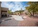 Well-maintained backyard with desert landscaping, mature trees, and a concrete patio, offering a private oasis at 2737 Tumble Brook Dr, Las Vegas, NV 89134