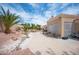 Beautiful backyard with desert landscaping, mature trees, and a concrete patio perfect for outdoor enjoyment at 2737 Tumble Brook Dr, Las Vegas, NV 89134