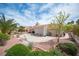Expansive backyard featuring desert landscaping, a concrete patio, and mature trees, creating a peaceful retreat at 2737 Tumble Brook Dr, Las Vegas, NV 89134