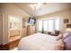 Comfortable bedroom with bay windows, hardwood floors and ensuite bathroom at 2737 Tumble Brook Dr, Las Vegas, NV 89134