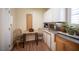 This cozy breakfast nook features cabinets, marble countertops, and natural light from a window at 2737 Tumble Brook Dr, Las Vegas, NV 89134