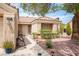 Inviting front entrance with well-manicured desert landscaping and a lighted walkway to the front door at 2737 Tumble Brook Dr, Las Vegas, NV 89134