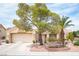 Charming single-story home boasts a desert landscape, mature trees and an attached two car garage at 2737 Tumble Brook Dr, Las Vegas, NV 89134