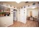 Bright kitchen with white cabinets, a pass-through window, and access to the breakfast nook at 2737 Tumble Brook Dr, Las Vegas, NV 89134