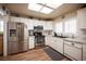 Well-lit kitchen features stainless steel appliances, white cabinets, and marble countertops at 2737 Tumble Brook Dr, Las Vegas, NV 89134