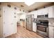 Open kitchen with stainless steel appliances, white cabinets, marble countertops, and breakfast nook at 2737 Tumble Brook Dr, Las Vegas, NV 89134