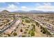 Elevated aerial shot of a lovely residential neighborhood with a golf course nestled among the homes and green spaces at 3016 High Range Dr, Las Vegas, NV 89134