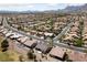 Wide aerial view of a sprawling residential neighborhood featuring lush landscaping and attractive single-Gathering homes at 3016 High Range Dr, Las Vegas, NV 89134