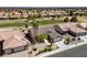 Beautiful aerial perspective of a desert home located adjacent to a lush green golf course in a vibrant community at 3016 High Range Dr, Las Vegas, NV 89134